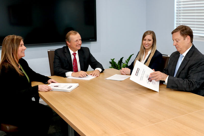 Certified Financial Fiduciaries sitting at a table during a meeting