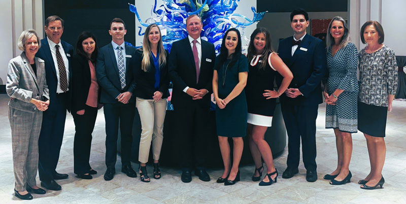 team at Nelson Financial Planning standing in front of sculpture at a museum