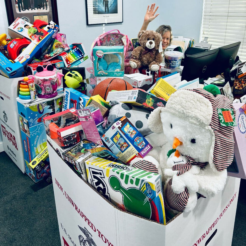 Nelson Financial Planning office crowded with boxes for Toys for Tots Florida event