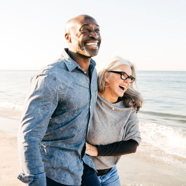 Senior couple walking on the beach